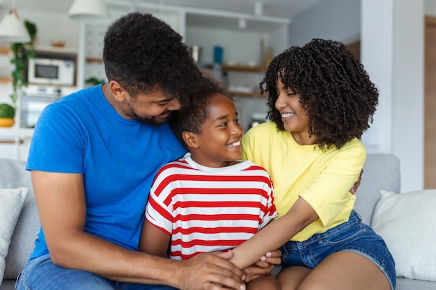 Happy family mother father and child daughter laughing and havig fun at home Happy African American family relaxing