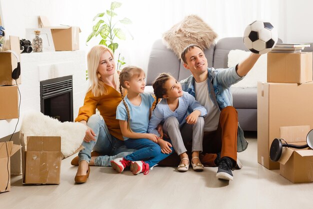 Happy family moving home with boxes around