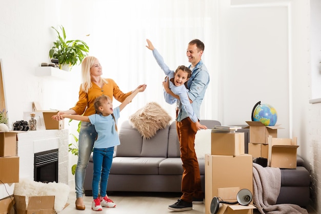 Happy family moving home with boxes around