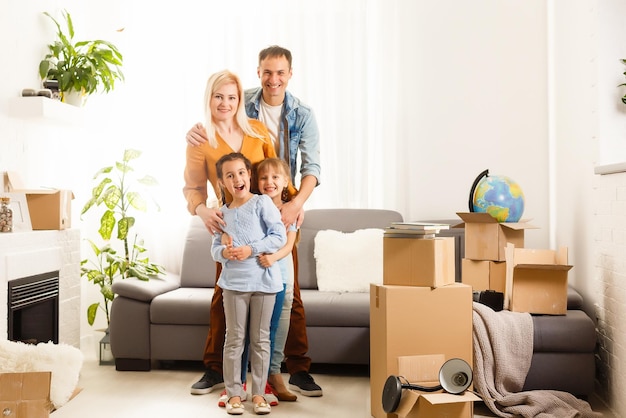 Happy family moving home with boxes around