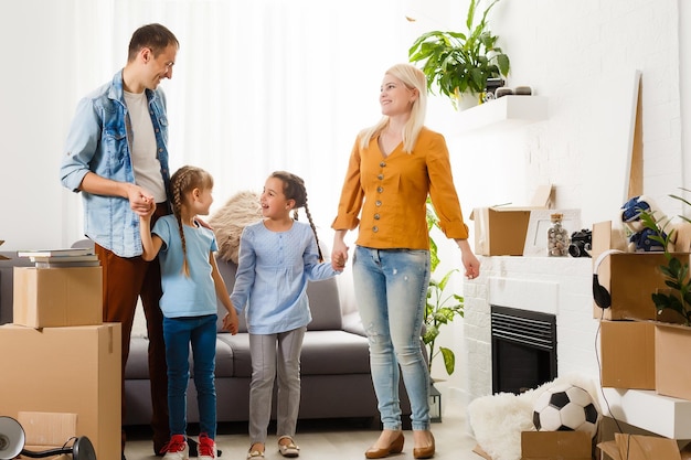 Happy family moving home with boxes around