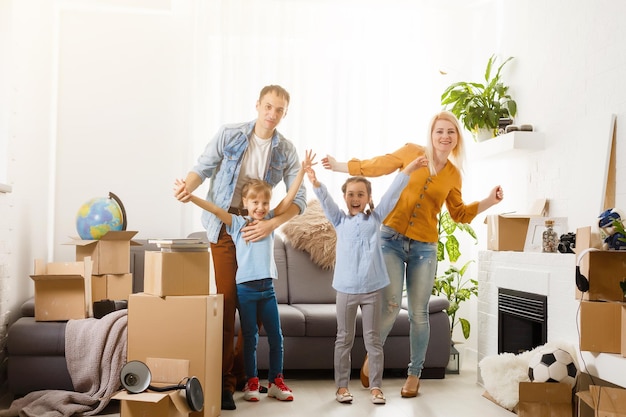 Happy family moving home with boxes around