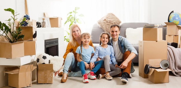 Happy family moving home with boxes around