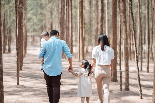 Happy family in the nature travel family on weekend playing together in the forest