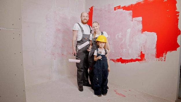 Happy family in overalls are smiling and looking at camera