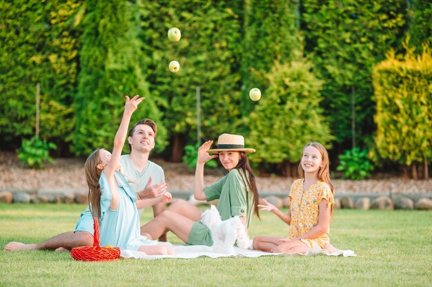 Happy family on a picnic in the park on a sunny day