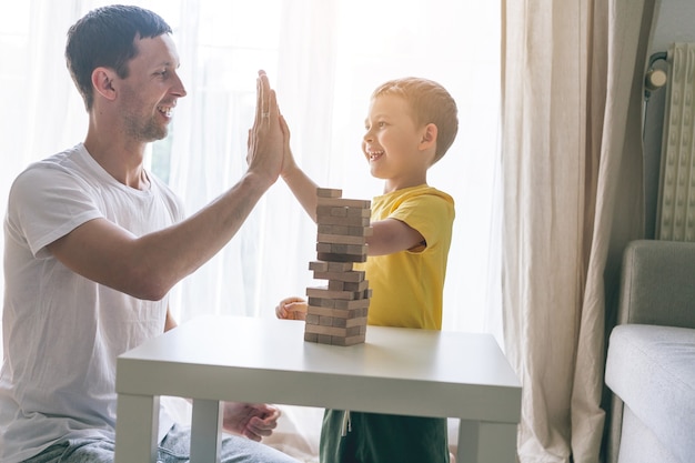 Happy family playing board game together. Home. Cozy.