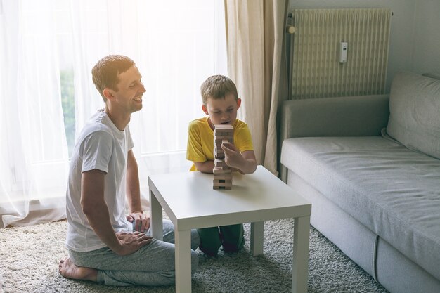 Happy family playing board game together. Home. Cozy.