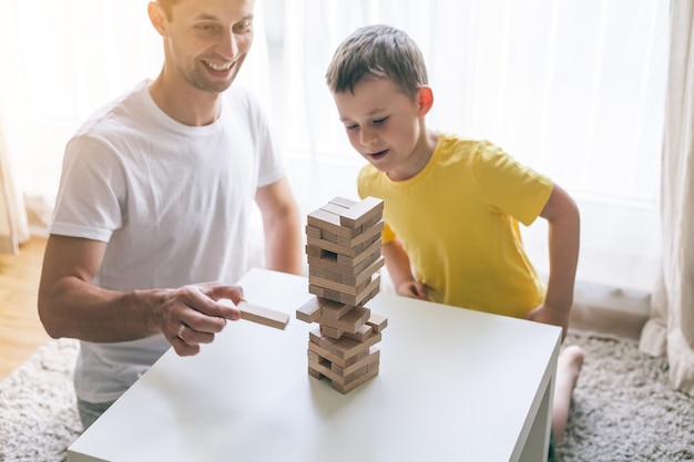 Happy family playing board game together. Home. Cozy.