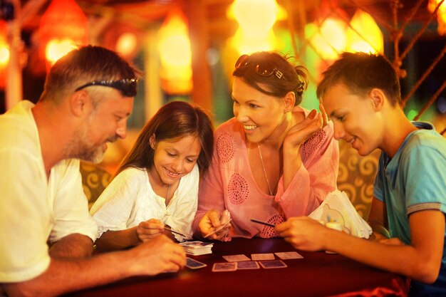 Happy family playing cards