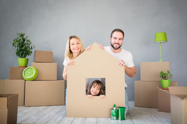 happy family playing into new home father mother and child having fun together moving house day