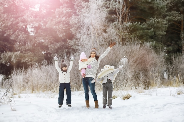 happy family playing and laughing in winter outdoors in snow. city park winter day.