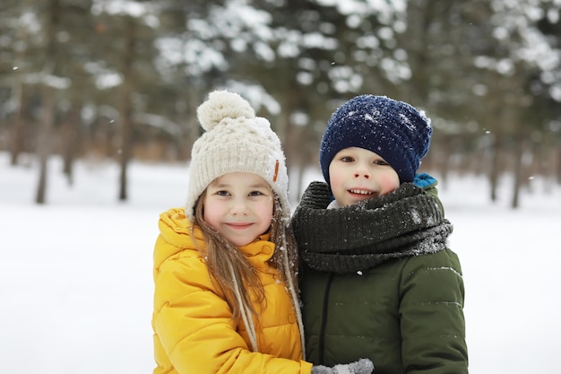 Happy family playing and laughing in winter outdoors in the snow. City park winter day.