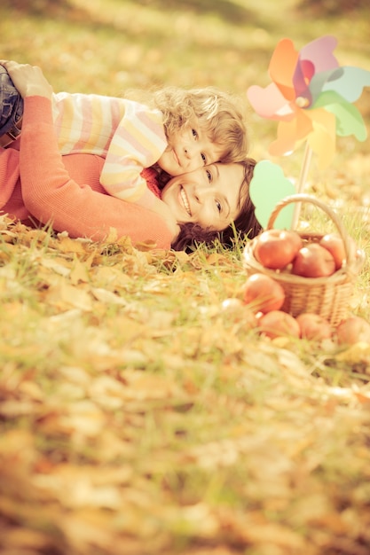 Happy family playing outdoors in autumn park