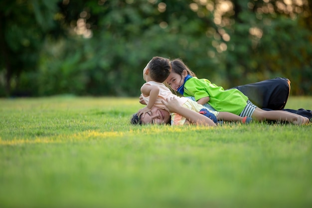 Happy family playing in the park. Mother and son play together in nature in the summer