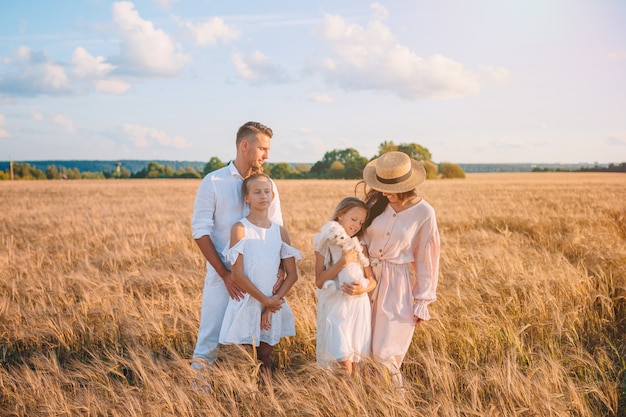 Happy family playing in a wheat field