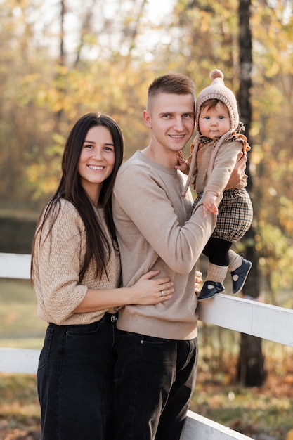 Photo happy family playing while walking in a park