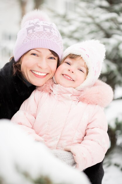 Happy family playing in winter outdoors