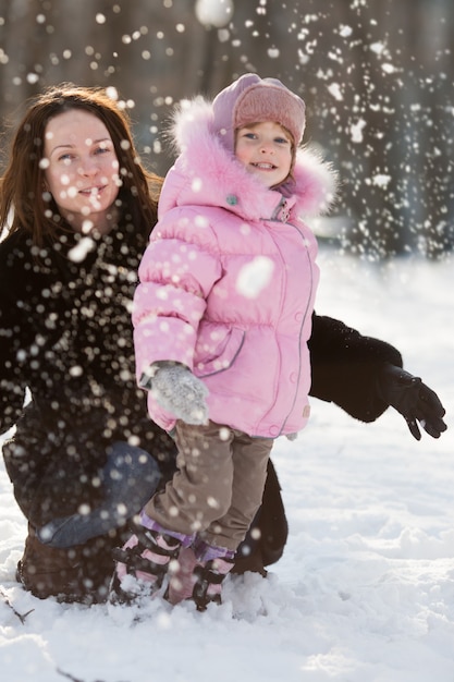 Happy family playing in winter park