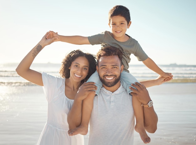 Happy family portrait and beach holiday with parents bonding with their son playful ocean fun Love travel and family time with young man and woman enjoying a sea trip with their smiling son