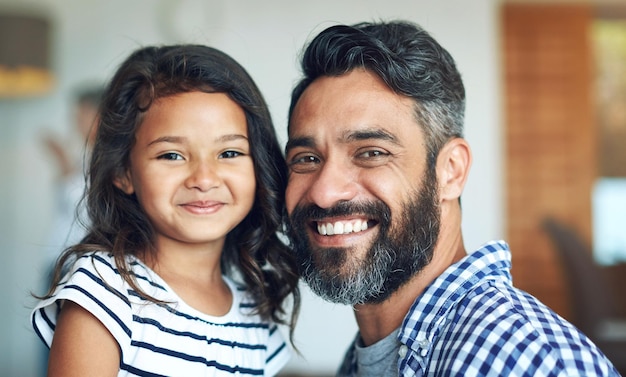 Happy family and portrait with child and dad together with smile and bonding in a new home Support happy and kid with youth solidarity and lounge with proud man and care in house with love