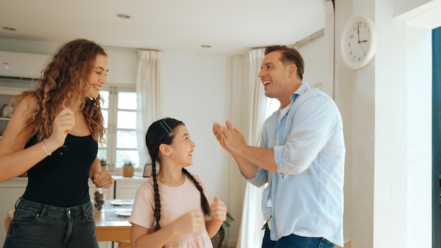 Photo happy family portrait with little girl smiling with her parent synchronos