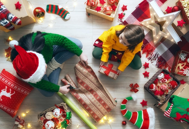 Happy family preparing for Christmas. Mother and her daughter decorating home for holidays.