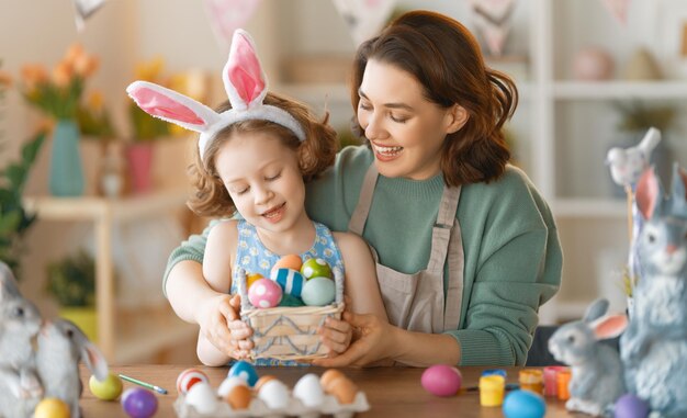 Happy family preparing for Easter Cute little child girl wearing bunny ears