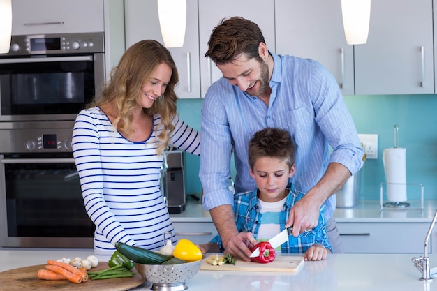 Happy family preparing vegetables together