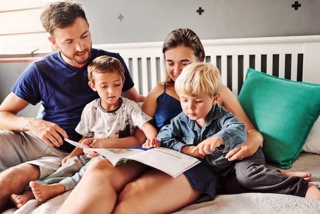 Photo happy family reading story book at home