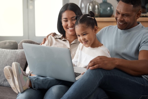 Photo happy family and relax on sofa with laptop in home living room for watching streaming movie or website black parents girl and watch cartoon movies together on technology computer or screen