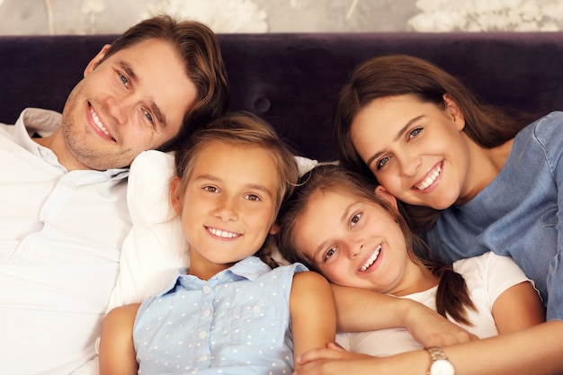 happy family relaxing in hotel room