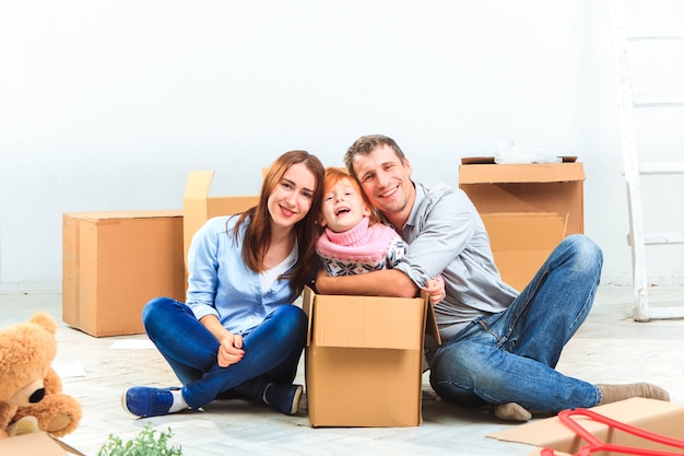 The happy family  at repair and relocation on a background of boxes