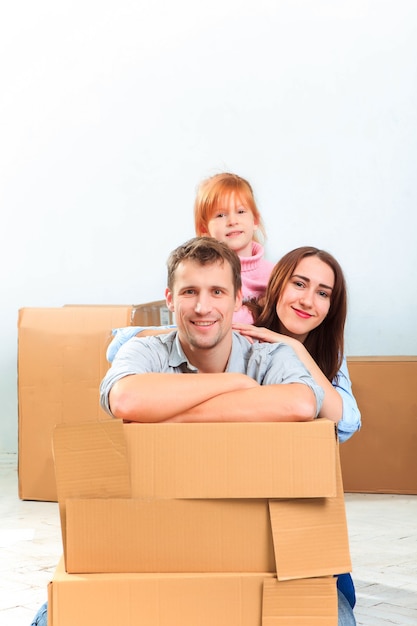 The happy family  at repair and relocation on a background of boxes