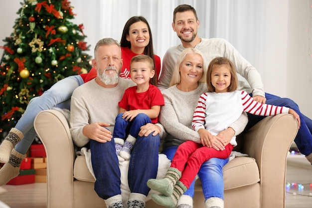 Happy family resting in room decorated for Christmas