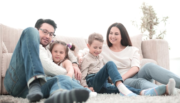 Happy family rests in the living room on a free eveningphoto with copy space