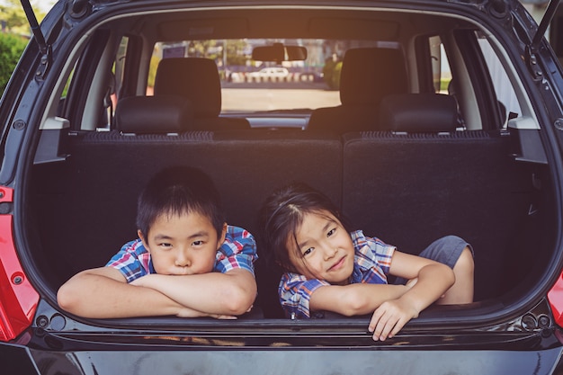 Happy family on a road trip, Sitting In Trunk Of Car