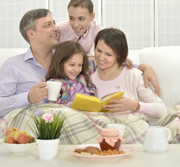 Happy family  in a room reading book