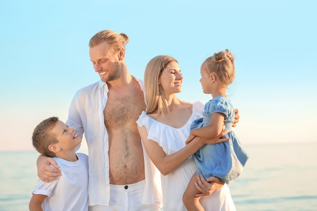 Happy family on sea beach at resort