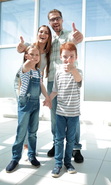 Happy family showing thumbs up photo with copy space