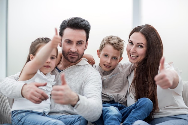 Happy family showing thumbs upthe concept of family