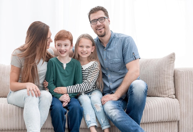 Happy family sitting on the couch in the living roomphoto with copy space