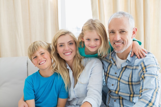 Happy family sitting on couch together