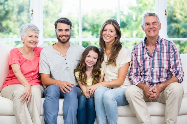 Happy family sitting on sofa at home