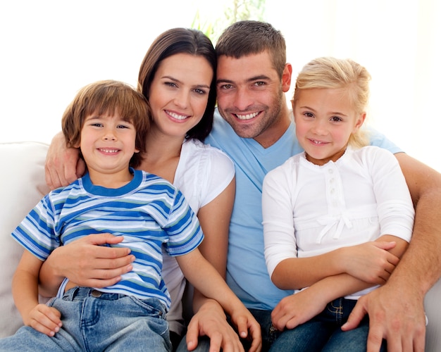 Happy family sitting on sofa at home