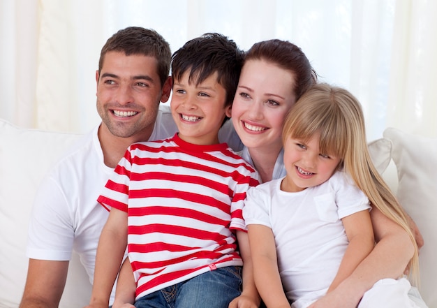 Happy family sitting on sofa together