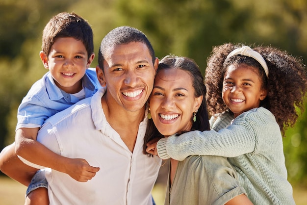 Photo happy family and smile of a mom dad and children in a park in nature having fun in summer portrait of parents and young kids from mexico with happiness playing outdoors with youth care together