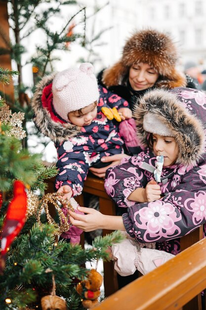 Happy family spend time at a christmas street market fair in the old town tallinn in estonia