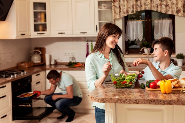 Happy family spending time in the kitchen preparing food