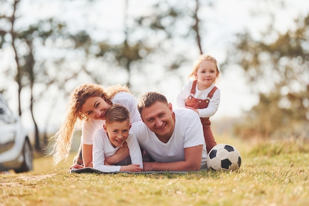 Happy family spending weekend together outdoors near the forest With daughter and son